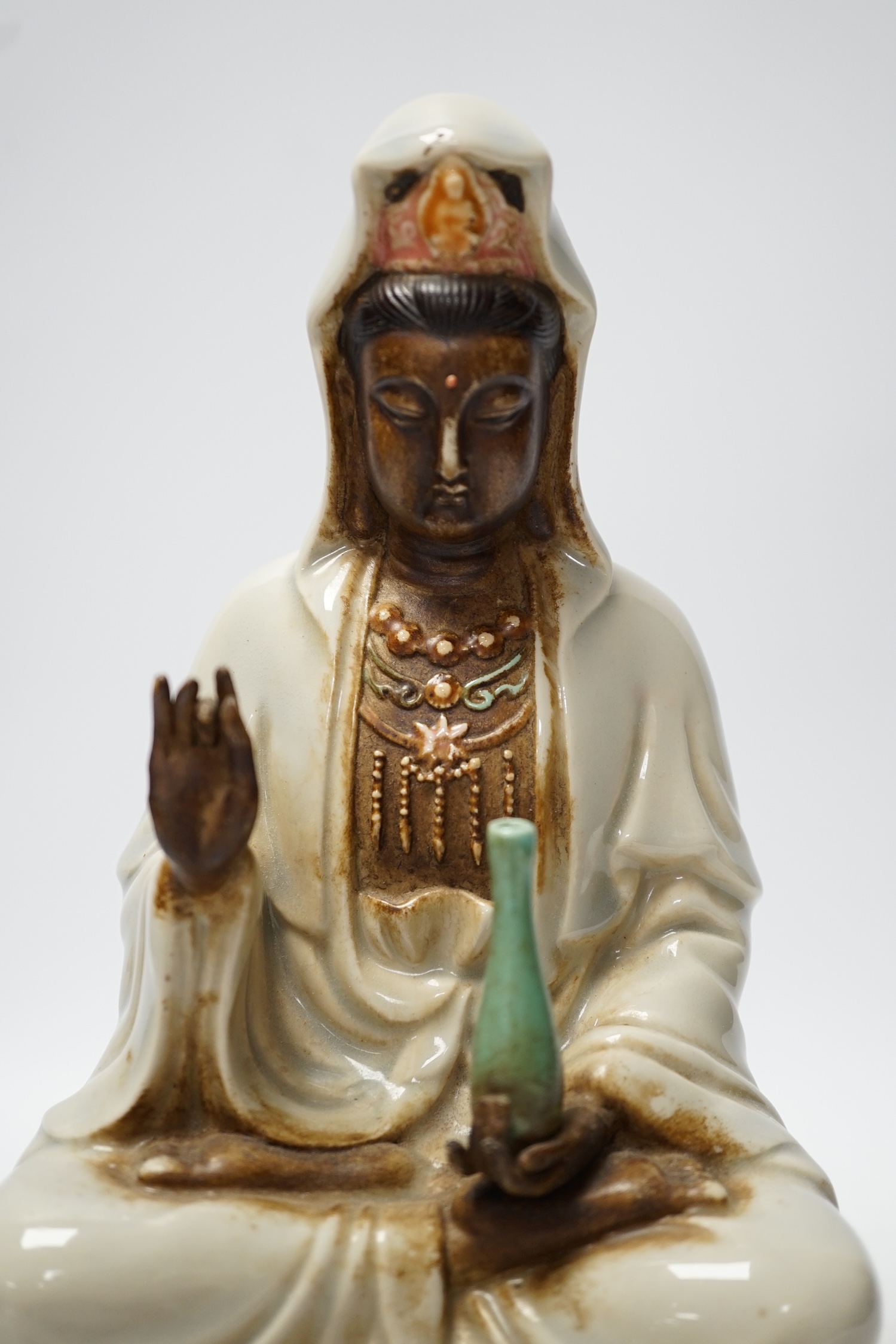A Chinese enamelled porcelain figure of Guanyin, 19th century, 25cm high. Condition - fair